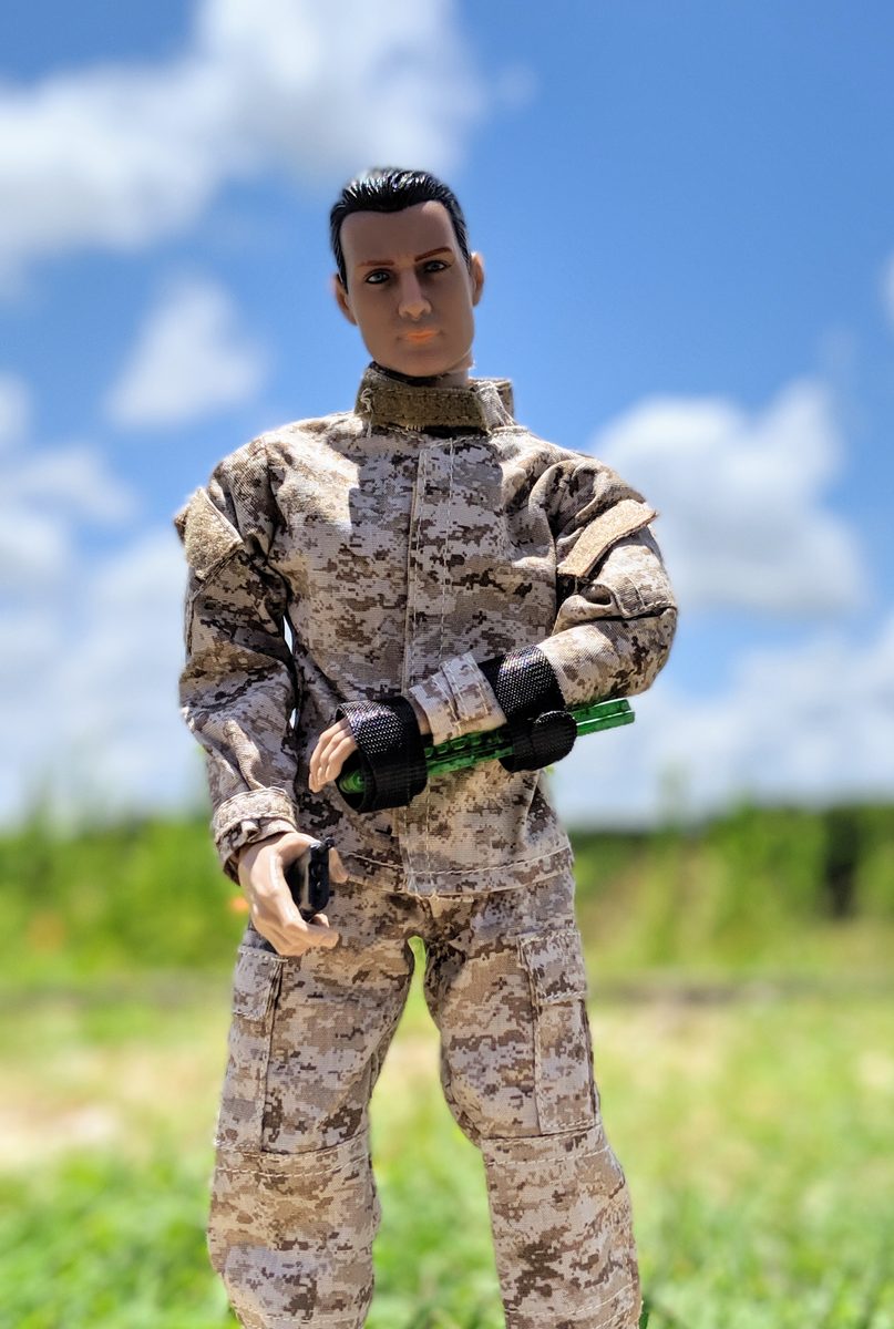 Neon-green Set-Lock Splint prototype strapped to an action-figure forearm